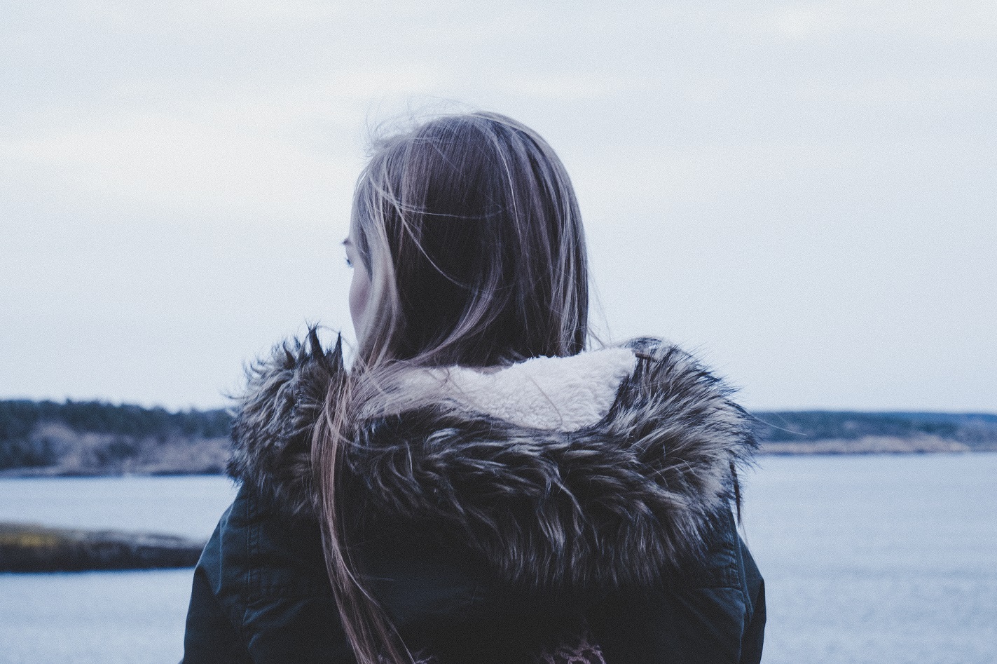 Girl looking away over water